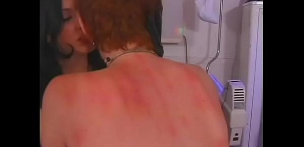  Redheaded slave with whip welts on ass gets EKG paddles on tits from BDSM hottie